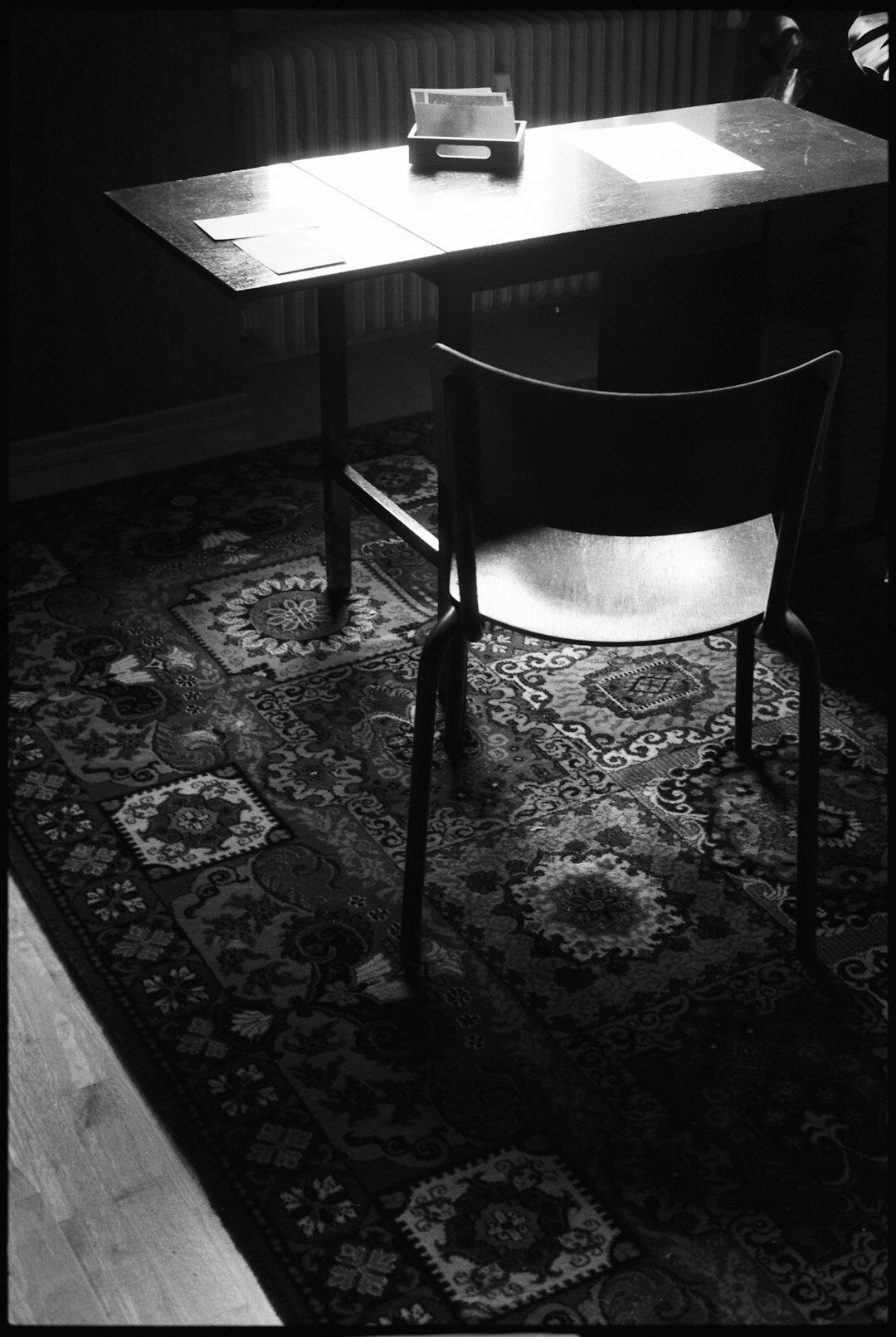 Portrait of a Dutch middle-aged male crime fiction author sitting at a wooden writing desk